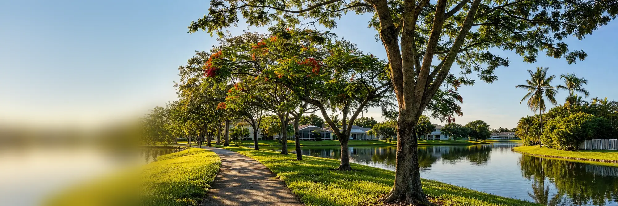 A lakeside path in Coconut Creek on a bright morning.
