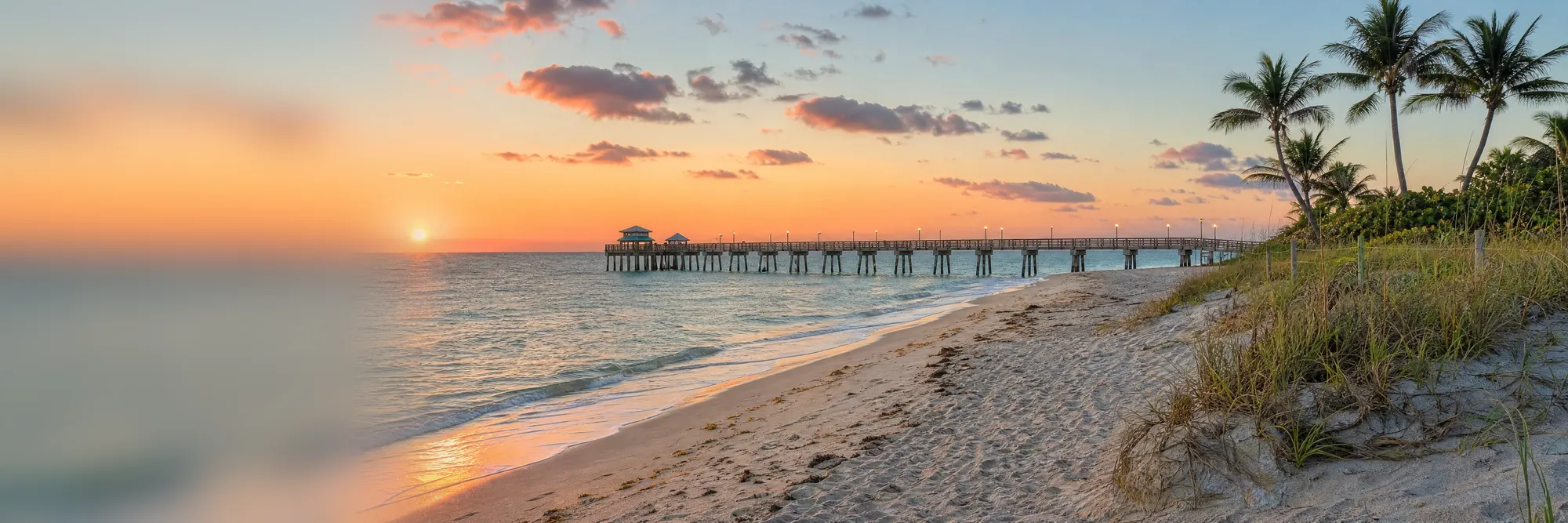 Sunrise over a fishing pier and the Atlantic.