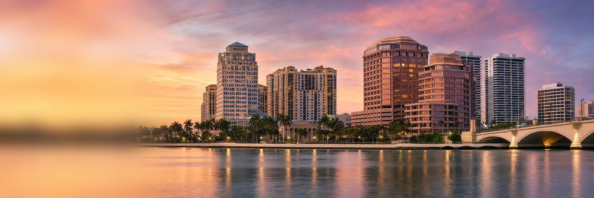 The West Palm Beach skyline across the Intracoastal at sunset.